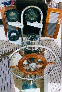 This is the cockpit of a typical Baba 30. The cockpit well is small
to minimize the impact of boarding seas. The cockpit deck is teak. Many of the
boats have wheel st…
