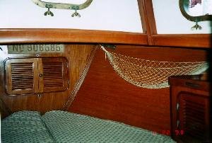 This is the typical V-berth found on a Baba 30. The chain locker is
accessible through the doors shown. Port and starboard lockers, combined with
drawers and general s…